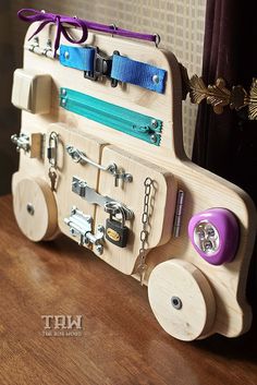 a wooden toy train with many items attached to it