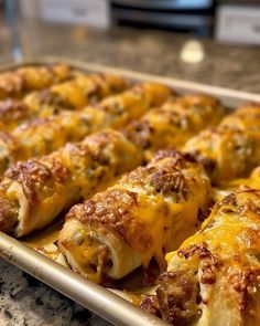 a baking pan filled with cheesy bread rolls