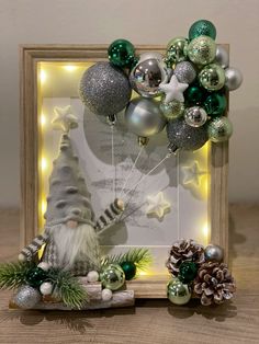 an image of a christmas decoration in a frame with lights and ornaments on the side