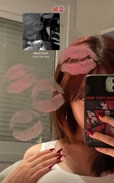 a woman taking a selfie in front of a mirror with her hair pinned back