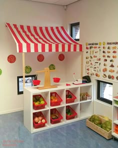 a display in a children's playroom with fruits and vegetables on the shelves