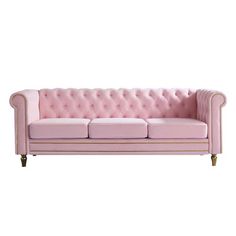 a pink couch sitting on top of a white floor