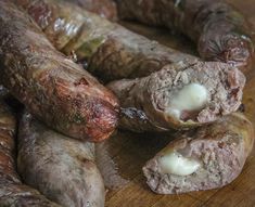 some sausages are on a wooden cutting board