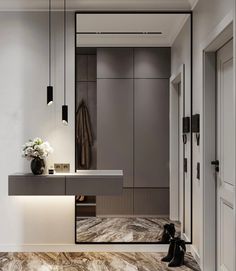 a modern bathroom with marble flooring and white walls, along with a large mirror on the wall