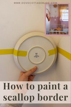 a person holding a white plate with yellow tape on it and the words how to paint a sealop border