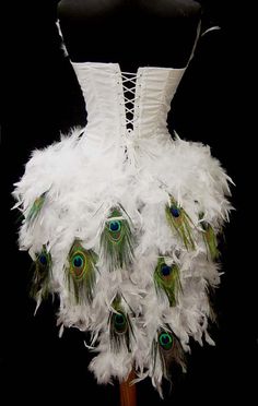 a white corset with peacock feathers on it