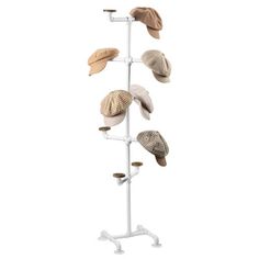 several hats are hanging on a white stand with hooks and pegs to keep them dry