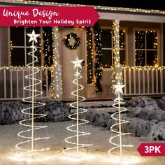 three lighted christmas trees in front of a house with the words unique design brighten your holiday spirit