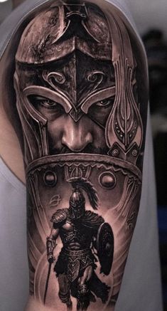 a man's arm with a black and grey tattoo on it, depicting a warrior