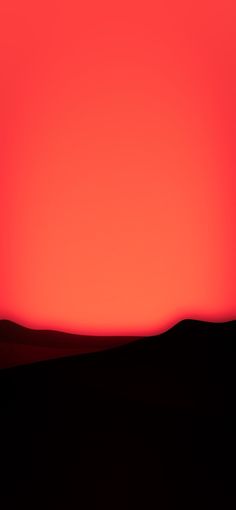 an orange and red sky with the sun setting in the distance, over some hills