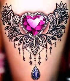 a woman's stomach with an intricate tattoo design on it and a pink heart in the center