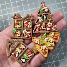 small christmas cookies in the palm of someone's hand on a tiled surface,