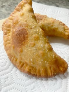 two pieces of pie sitting on top of a white napkin