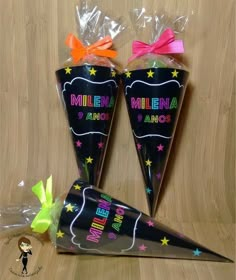 two black cones with neon stars and the words millenia amoe on them