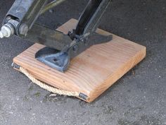 a piece of wood that has been placed on the ground with a machine attached to it