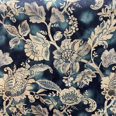 a blue and gold floral pattern on fabric