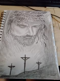 a drawing of jesus with three crosses