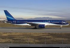 a blue and white airplane is on the runway