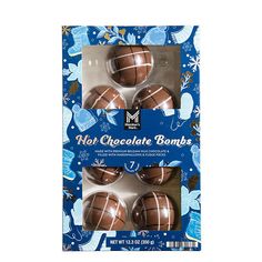 three chocolate balls in a package on a blue background with snowflakes and flowers