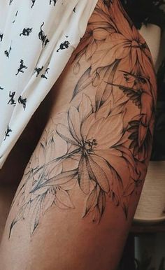 a woman's thigh with flowers on it