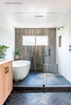 a bathroom with a tub, sink and shower in it's own area is shown