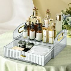 an assortment of perfumes in a mirrored tray on a table