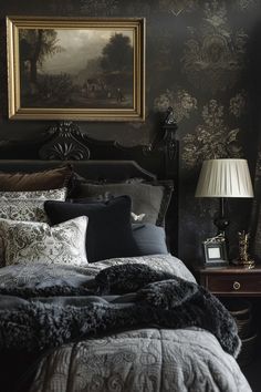 a bed with black and white comforter in a bedroom next to a painting on the wall