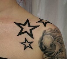 a woman's shoulder with three stars on the top and one star in the middle