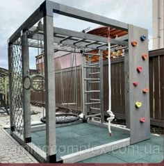 an outdoor climbing wall made out of wood and metal with ropes attached to the side