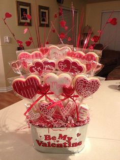 valentine's day cookies in a bucket on a table