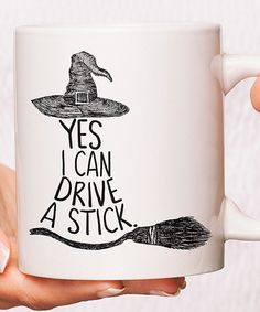 a person holding a coffee mug with the words yes i can drive a stick on it