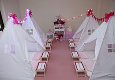 a pink and white birthday party with teepee tents