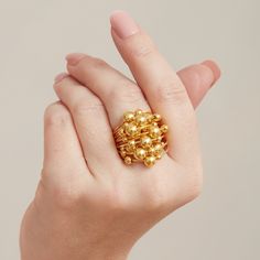 Gold bubble statement ring made using sterling silver and 18 carat gold.  All the materials I use are real Sterling Silver and 18 carat gold. I do not use inferior metals such as Gold fill or Brass Gold plated! This statement gold beaded bobble ring is such fun! Each gold ball moves across the band like an abucas, giving even more character to its style. Stack with other gold and gemstone rings in yoir collection or simply wear by itself, this ring is a great piece which will match anything in your wardrobe! This ring is available in size 7/N/54. Please see listing below for matching earrings: https://www.etsy.com/uk/listing/818558522/gold-hoop-earrings-small-gold-hoop There are many other gold rings in my shop, take a peek! Each item comes with a satin pouch. I can also present them in a Large Gold Ring, Gold Bubbles, Small Gold Hoops, Garnet And Gold, Aquamarine Earrings, Tourmaline Bracelet, Gold Cocktail Ring, Gold Statement Earrings, Tourmaline Jewelry