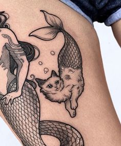 a woman with a cat on her thigh next to a mermaid and a fish tattoo