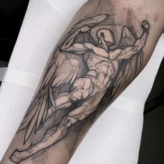 a man's arm with an angel tattoo on it, in black and white