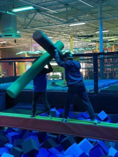 two people are playing with a giant baseball bat