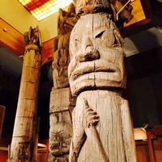 a large wooden statue sitting inside of a building