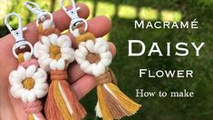 hand holding four tassels with the words daisy how to make them in it