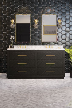 a bathroom with two sinks and mirrors on the wall next to a vase filled with flowers