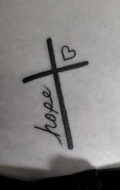 a cross with the word hope written in cursive writing on it and a heart at the bottom