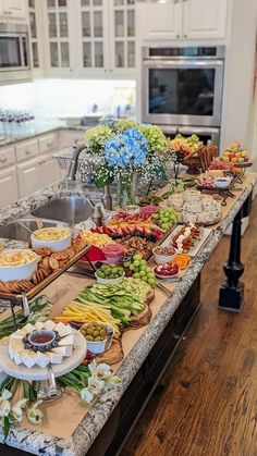 a kitchen counter topped with lots of different types of food on top of it next to a sink