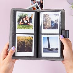 a woman holding an open photo book with photos on it