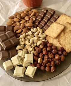 an assortment of nuts, crackers, and bars on a plate