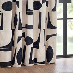 a curtain with black and white shapes on it