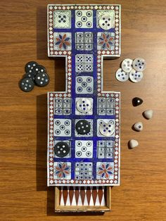 a wooden table topped with different types of buttons and paper machs on top of it