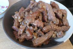 a close up of a bowl of food with meat