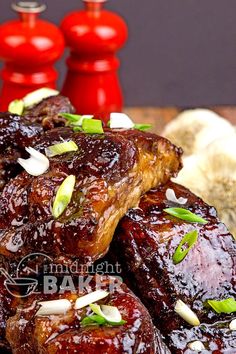 barbecued ribs covered in bbq sauce and garnished with green onions