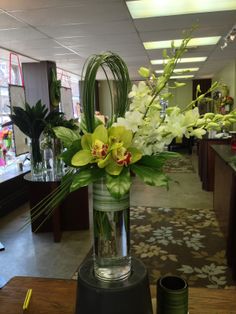 a vase filled with flowers on top of a wooden table