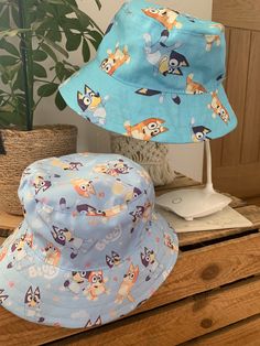 "Handmade Bluey bucket hat.  Made to order by myself - available in 4 sizes: XS fits 21\" head,  S fits 22\", M fits 23\" and L 24\". Lined with co-ordinating fabric.  Please let me know at checkout if you have a preference of lining colour. As these are handmade to order, I am happy to make a custom size, especially for you bigger kids and adults out there too - just send me a message." Bluey Shoes, Blue Crocs, Bluey And Bingo, Character Cakes, Easy Packing, When I Grow Up, Bucket Hats