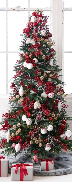 a decorated christmas tree with presents under it